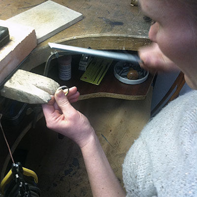 filing rough edges in a ring workshop